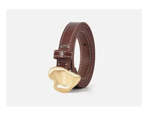Detail view of brown leather belt with gold irregular heart buckle and white stitching.
