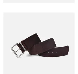 Close-up dark brown suede belt detail with minimalist metal pin buckle for dress styling.