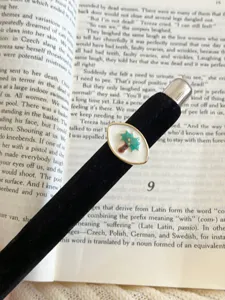 Fashionable black velvet band enamel ring with green plant motif, elegant accessory.