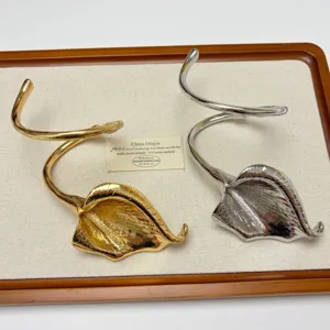 European vintage metal calla lily cuff bracelet, gold and silver twisted open bangle accessory.