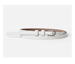 Close-up detail of a minimalist white thin leather belt with a sleek silver-toned metal buckle.