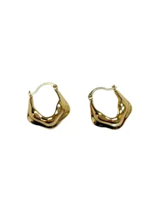 Close-up detail of irregular wavy gold hoop earrings, vintage geometric design for women.