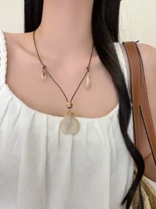 Bohemian natural seashell pendant necklace, adjustable brown cord choker, beach jewelry detail.