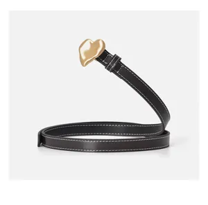 Detailed view of women black leather belt featuring chic gold heart buckle and stitches.