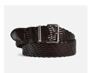 Detailed view of dark brown woven leather belt featuring a sleek metal buckle, classic retro style.