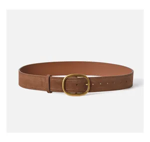 Elegant women's suede leather belt featuring a classic brass oval buckle for stylish outerwear.