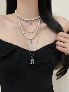 Vintage multi-layer pearl necklace with horseshoe pendant, elegant clavicle chain.