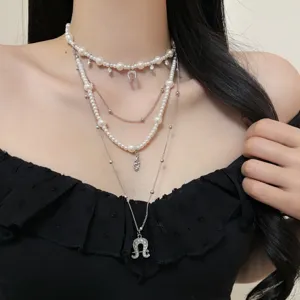 Vintage multi-layer pearl necklace with horseshoe pendant worn by model main view