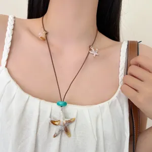 Chic bohemian ocean style starfish necklace with shell charms for women beach wear.