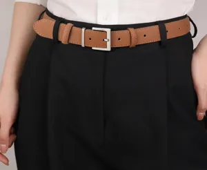 Closeup product detail of a brown leather belt featuring a silver square buckle worn on pants.