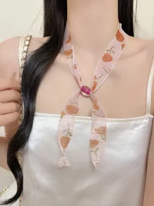 Chic floral print ribbon necklace with beaded centerpiece, perfect for spring and summer chic style.