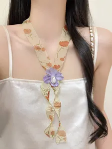 Vintage floral fabric ribbon necklace detail featuring a chic purple flower pendant for women.