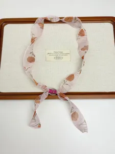 Floral chiffon ribbon necklace with beaded detail, retro style neck tie accessory for women.