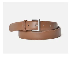 Close-up detail of a brown women leather belt with silver metal buckle and neat stitching.