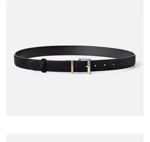 Detailed close-up of a black suede leather women's belt featuring a sleek silver square buckle.