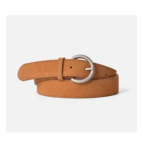 Brown suede belt with silver metal buckle, detail view of women's retro stylish waist accessory.