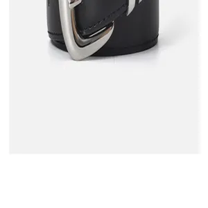 Detailed shot of women's black leather belt featuring a unique silver metallic buckle.