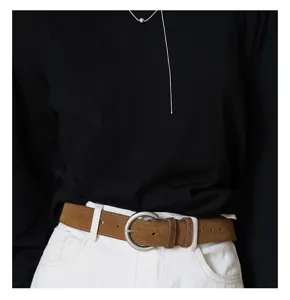 Detail view of the brown suede waist belt with metallic round pin buckle, stylish design.