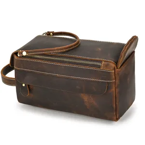 Close-up of retro genuine crazy horse leather toiletry bag zipper detail and portable handle.