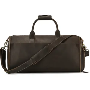 Dark brown leather travel duffel bag detail, showing premium stitching and metal hardware.
