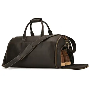 Detail view of the vintage brown leather travel duffel bag showing the side shoe compartment.