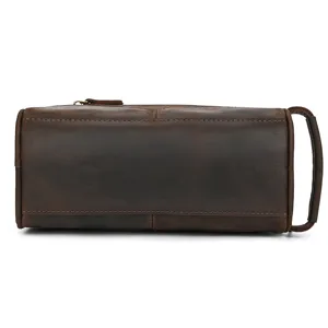 Detailed shot of vintage crazy horse leather toiletry bag, showcasing fine stitching and texture.