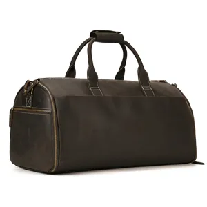Detailed view of brown leather travel duffel bag, showing vintage texture and stitching.