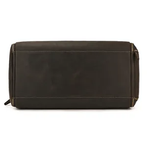 Detail shot of the vintage brown genuine leather travel duffel bag showing durable zippers and stitching.