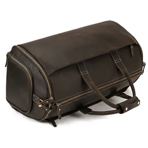 Close-up detail of vintage leather travel duffel bag featuring sturdy metal zippers.