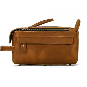 Detailed view of vintage brown crazy horse leather toiletry bag with sturdy zipper and handle.