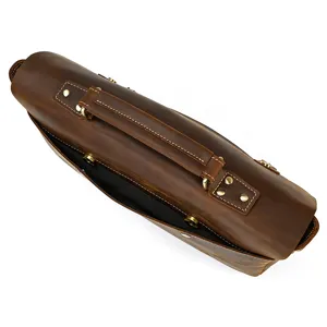 Detailed view of brown crazy horse leather briefcase handle and brass metal hardware.