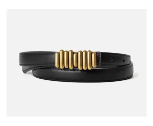 Detailed view of women's black leather belt featuring a unique gold vertical tube buckle.