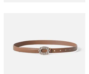 Detailed view of the brown leather belt featuring a sparkling rhinestone oval buckle design.