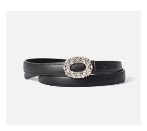Close-up view of a chic black leather belt featuring a dazzling rhinestone-paved oval buckle.