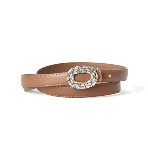 Women's brown leather belt featuring a sparkling rhinestone oval buckle for casual jeans.