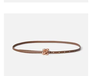Slim brown leather belt featuring an elegant metallic rose buckle, perfect for dresses and sweaters.