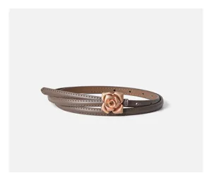 Detailed close-up shot of a brown thin leather belt featuring a rose gold floral metal buckle.