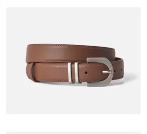 Brown genuine leather belt detail, matte silver pin buckle, double loops, fine stitching.