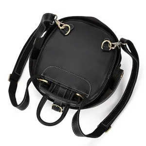 Detailed view of black round genuine leather backpack with unique beetle design and metal hardware.
