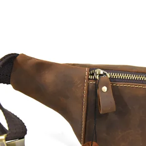 Close-up detail of vintage genuine crazy horse leather waist bag zipper and texture.