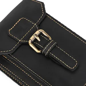 Black leather waist bag detail shot showing fine contrast stitching and metal buckle hardware.