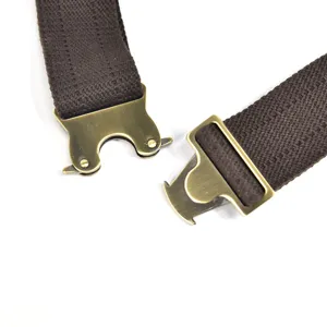 Detailed view of vintage brown fabric strap with unique antique brass metal buckle hardware.