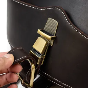 Detailed shot of dark brown genuine crazy horse leather backpack metal buckle and stitching.