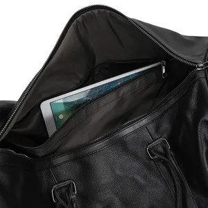 Vue détaillée de l'intérieur du sac de voyage en cuir noir avec poche zippée et tablette.