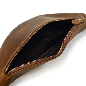 Detail shot of retro genuine leather waist bag showing interior zipper pocket and lining.