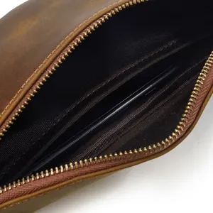 Detailed interior view of the open vintage leather bag, showing zipper and storage.