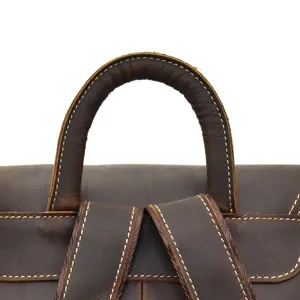 Close-up detail of crazy horse leather backpack top handle and sturdy straps design.