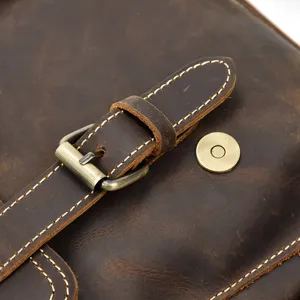 Close up view of vintage crazy horse leather backpack metal buckle detail, premium quality.