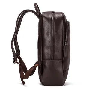 Detail shot of a dark brown leather backpack, showing durable pebbled leather and straps.