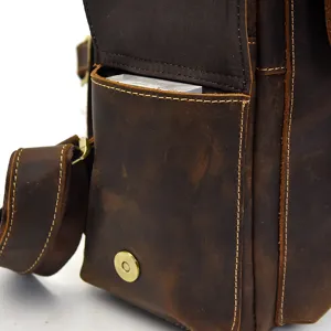 Genuine leather retro men bag detail close up, brown vintage messenger bag front pocket.